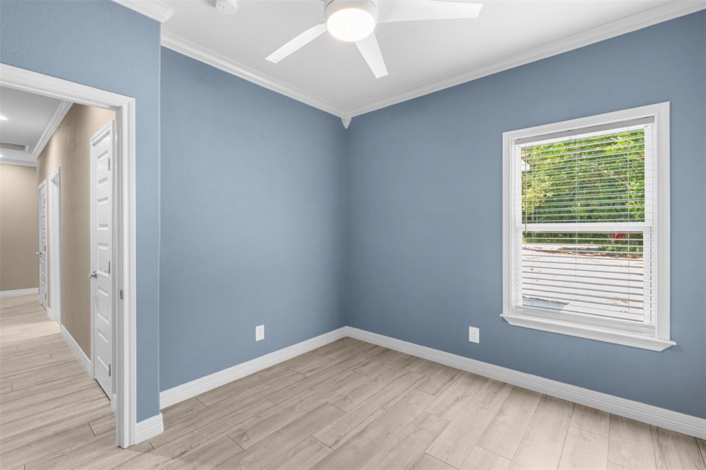 1011 Southeast County Road Corsicana, TX 75109 - Photo 21 of 40 a view of an empty room with wooden floor and a window