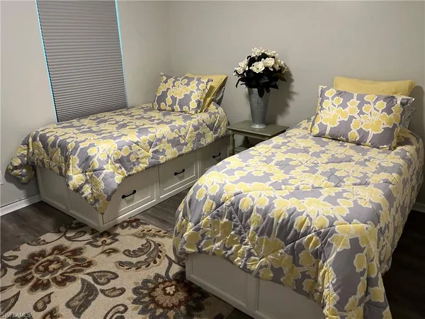 a bed sitting in a bedroom next to a lamp