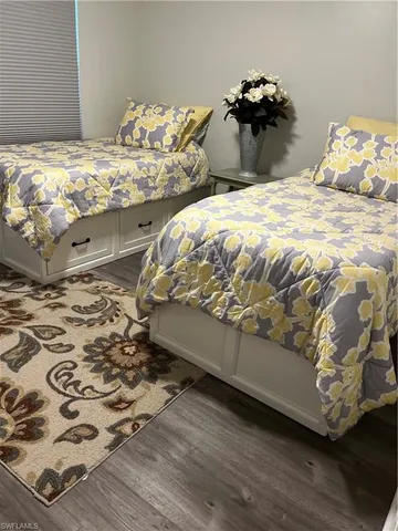 a bed sitting in a bedroom next to a bed