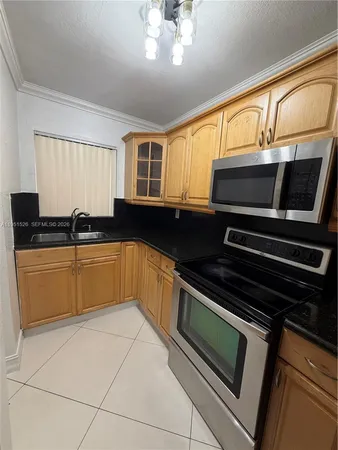 a kitchen with granite countertop a stove and a sink