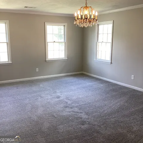 a view of a chandelier in big room and chandelier