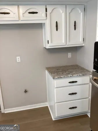 a view of a storage and utility room with cabinet