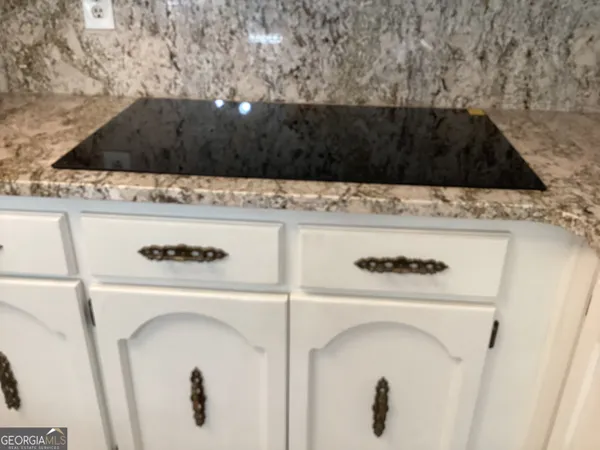 a white stove top oven sitting inside of a kitchen