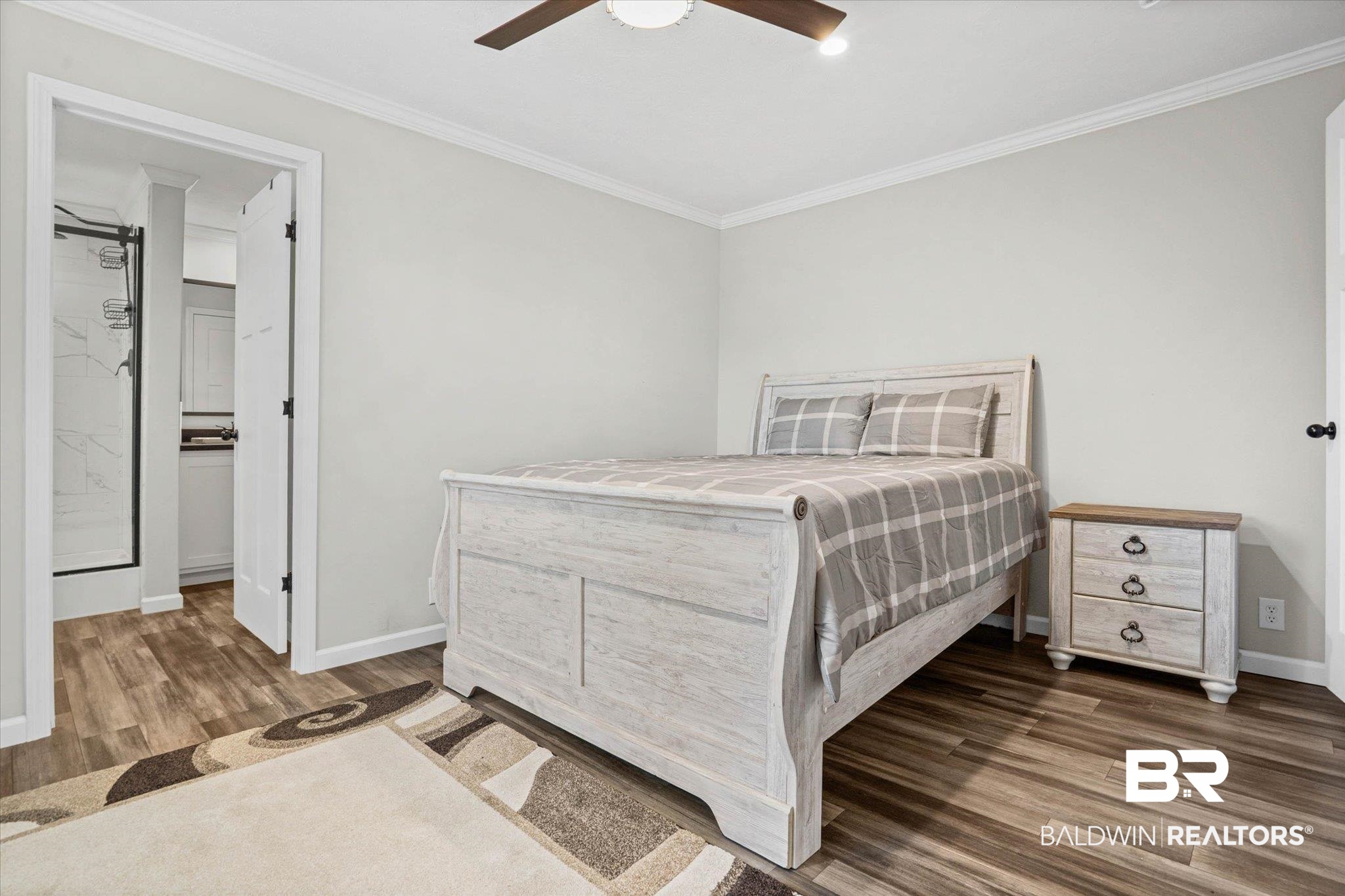 1325 Ridgewood Drive Lillian, AL 36549 - Photo 7 of 32 Bedroom with crown molding, wood finished floors, ceiling fan, and ensuite bath