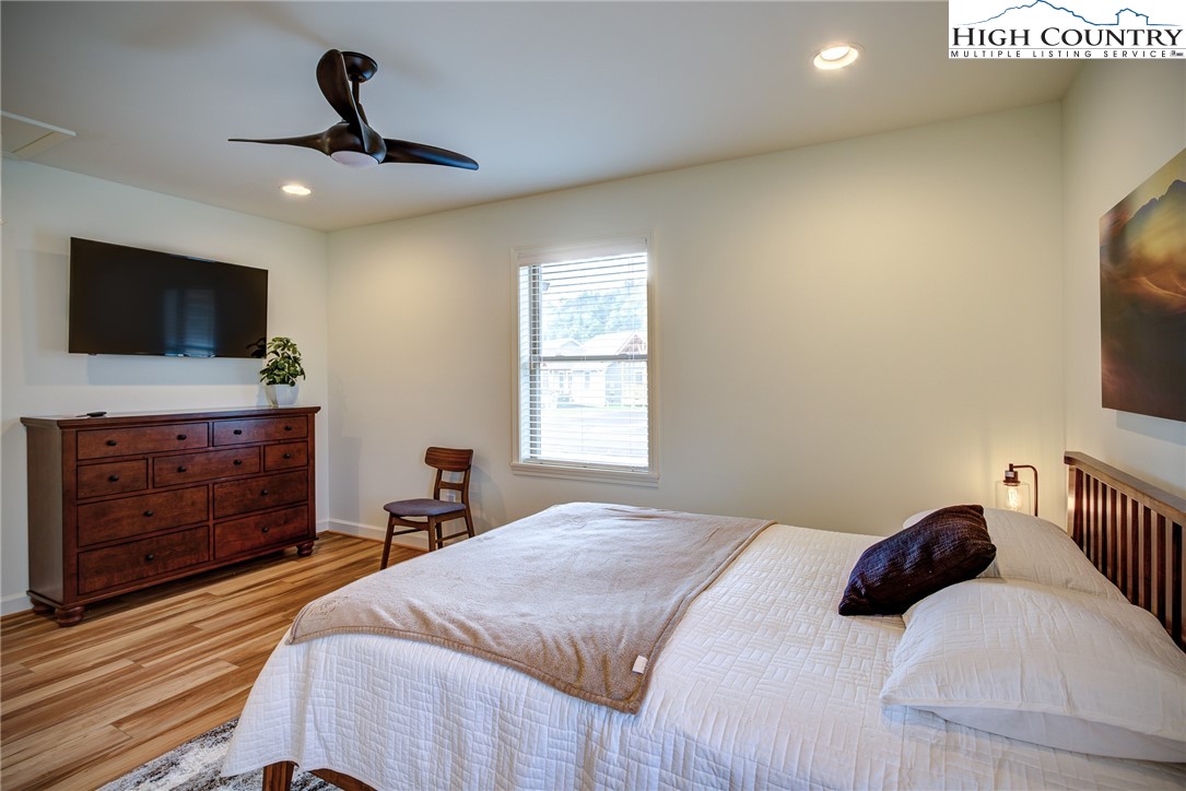 142 Casey Overlook Lane, Unit 82 Boone, NC 28607 - Photo 12 of 43 a bedroom with a bed and a flat screen tv