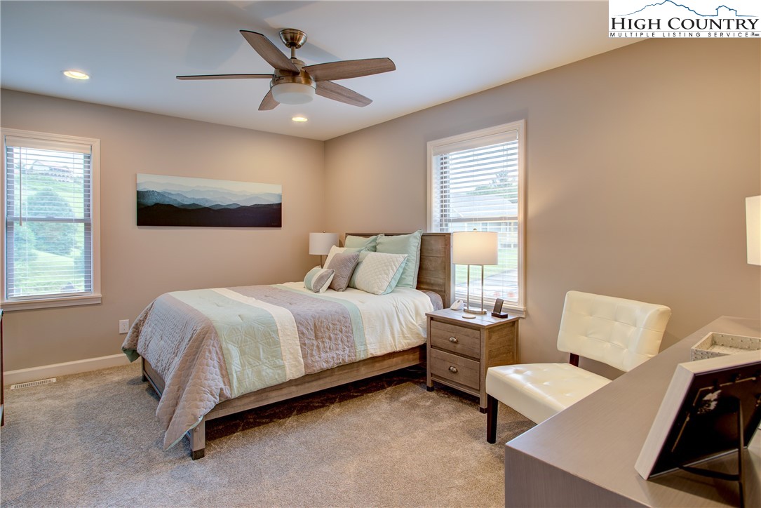 142 Casey Overlook Lane, Unit 82 Boone, NC 28607 - Photo 16 of 43 a bedroom with a bed and a large window