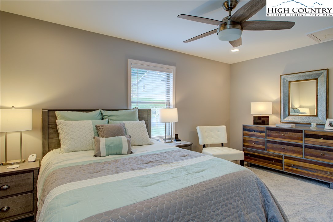 142 Casey Overlook Lane, Unit 82 Boone, NC 28607 - Photo 17 of 43 a bedroom with a bed and a chandelier