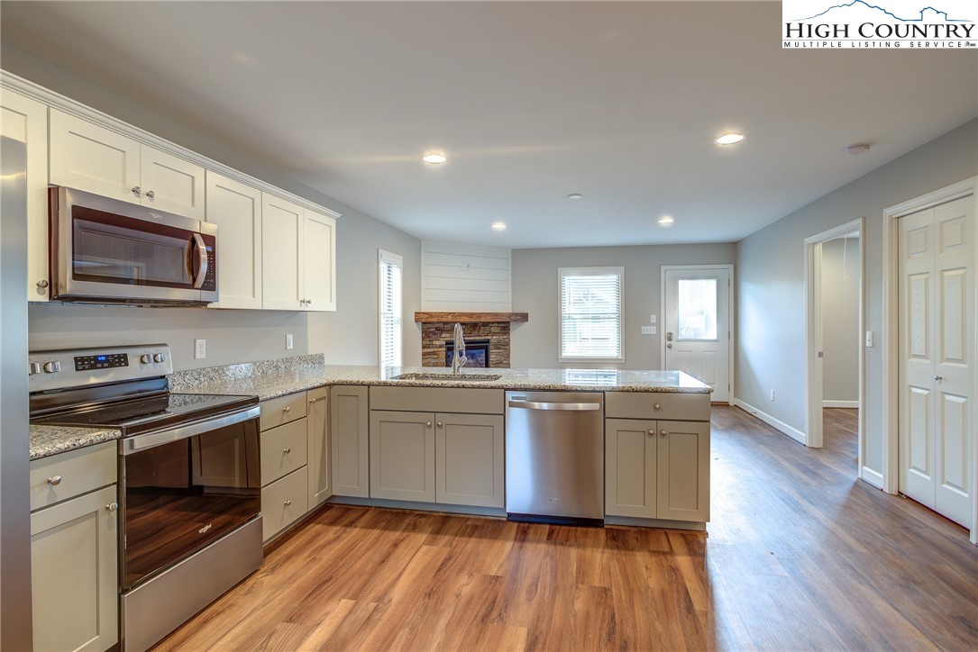 142 Casey Overlook Lane, Unit 82 Boone, NC 28607 - Photo 18 of 43 a kitchen with stainless steel appliances granite countertop wooden cabinets and a stove top oven