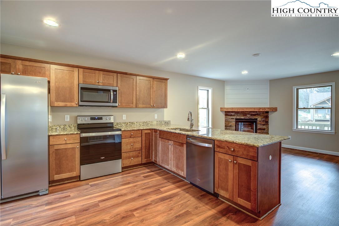 142 Casey Overlook Lane, Unit 82 Boone, NC 28607 - Photo 22 of 43 a kitchen with wooden cabinets and stainless steel appliances