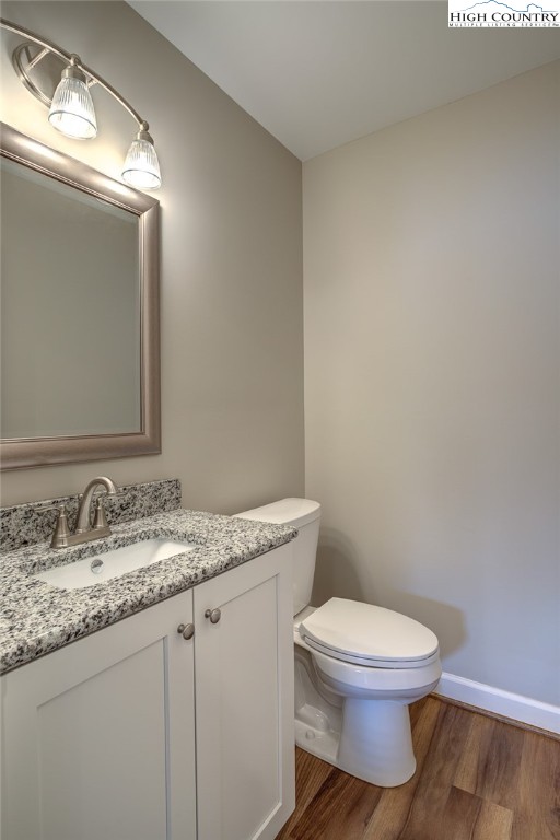 142 Casey Overlook Lane, Unit 82 Boone, NC 28607 - Photo 24 of 43 a bathroom with a granite countertop toilet a mirror and a sink