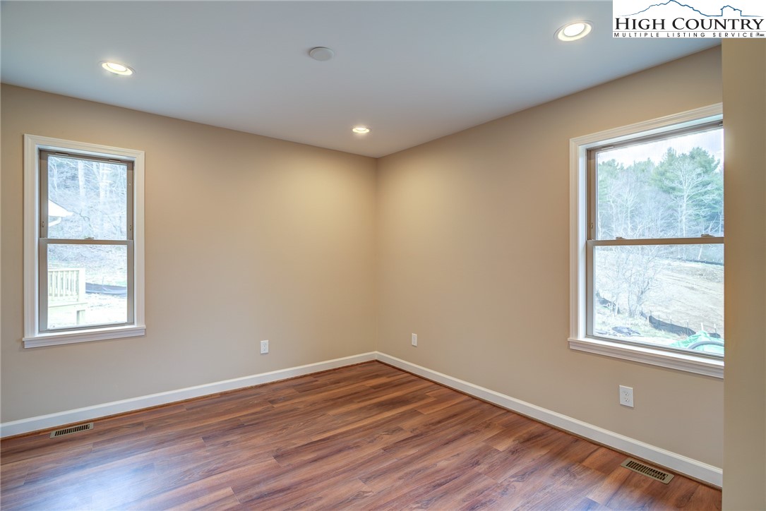 142 Casey Overlook Lane, Unit 82 Boone, NC 28607 - Photo 26 of 43 a view of an empty room with wooden floor and a window