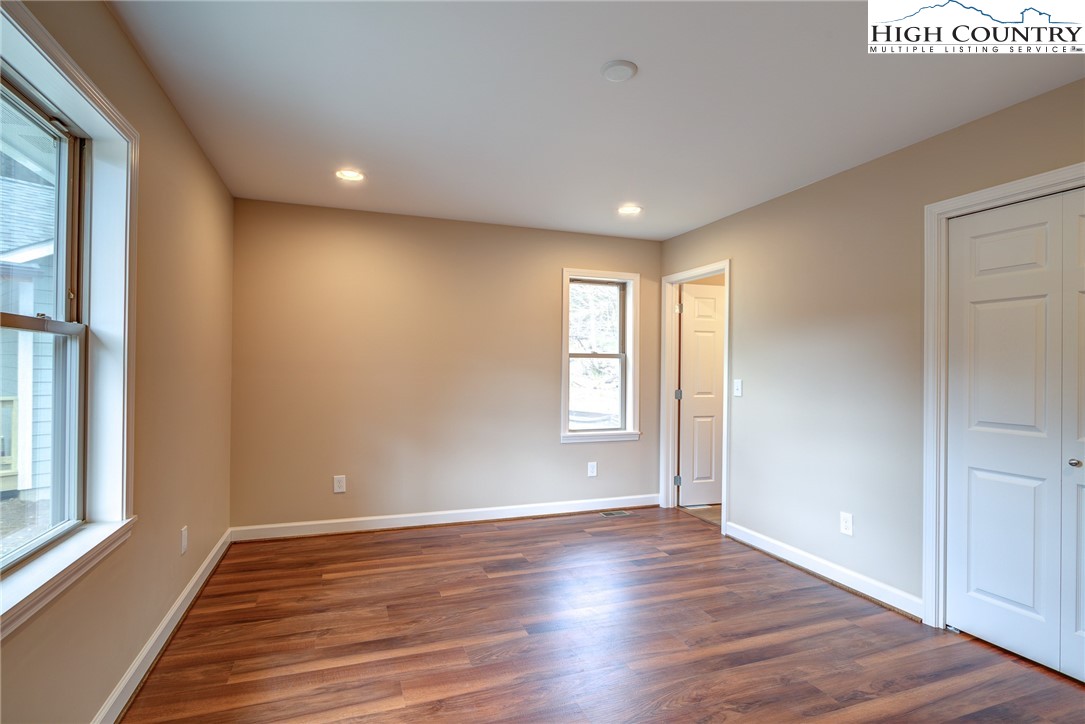 142 Casey Overlook Lane, Unit 82 Boone, NC 28607 - Photo 27 of 43 a view of an empty room with wooden floor and a window