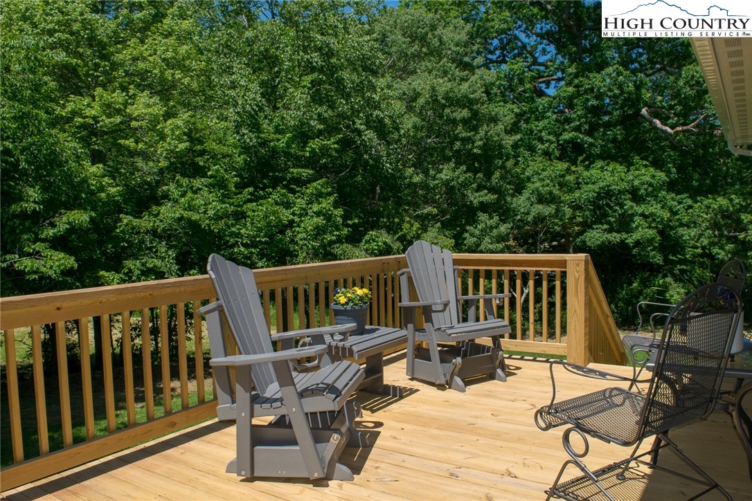142 Casey Overlook Lane, Unit 82 Boone, NC 28607 - Photo 32 of 43 a view of a chairs and table on the deck