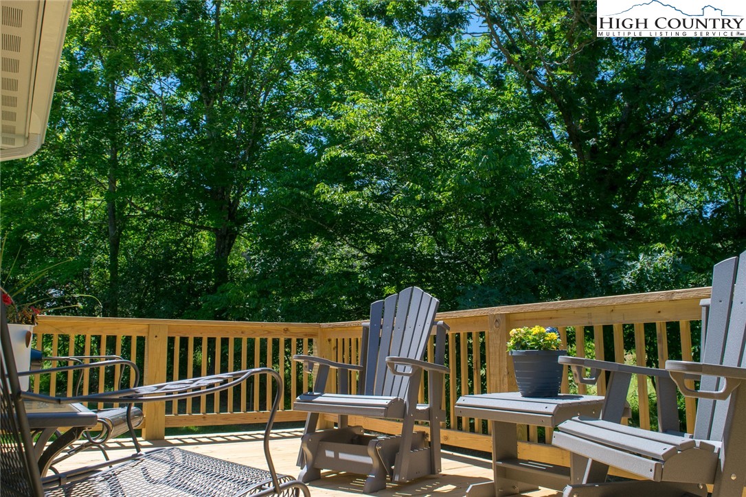 142 Casey Overlook Lane, Unit 82 Boone, NC 28607 - Photo 33 of 43 a view of a deck with two chair and wooden floor