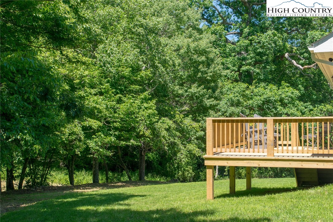 142 Casey Overlook Lane, Unit 82 Boone, NC 28607 - Photo 35 of 43 a view of a wooden deck and a yard