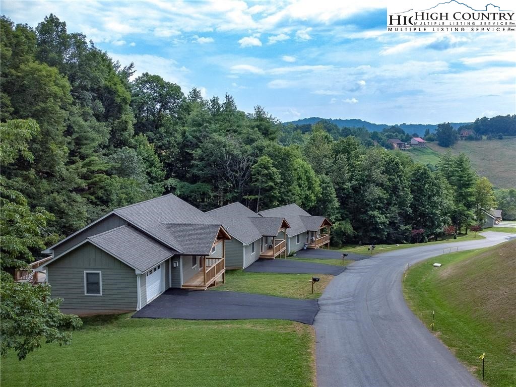 142 Casey Overlook Lane, Unit 82 Boone, NC 28607 - Photo 36 of 43 a aerial view of a house with a yard table and chairs