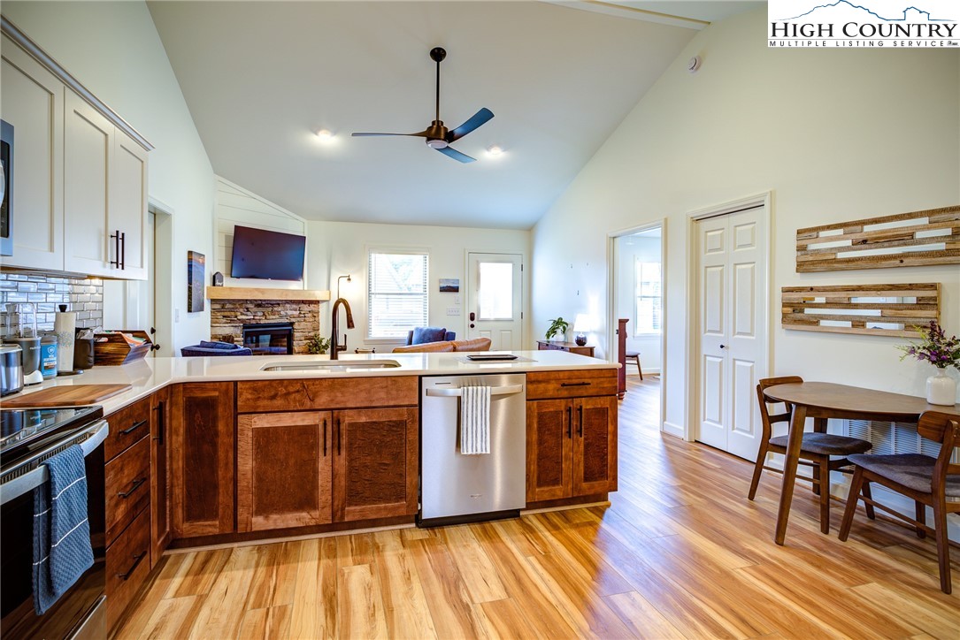 142 Casey Overlook Lane, Unit 82 Boone, NC 28607 - Photo 5 of 43 a large kitchen with stainless steel appliances granite countertop a stove and a wooden floors