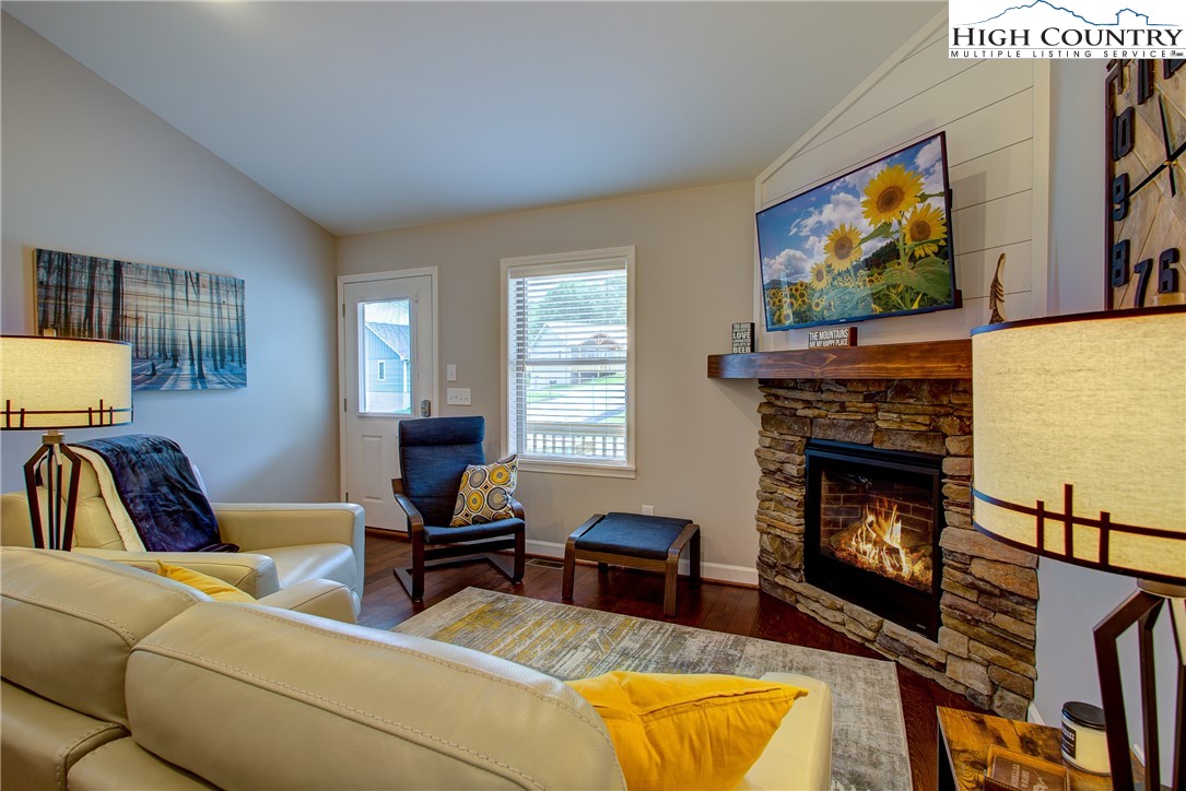 142 Casey Overlook Lane, Unit 82 Boone, NC 28607 - Photo 6 of 43 a living room with furniture a fireplace and a flat screen tv