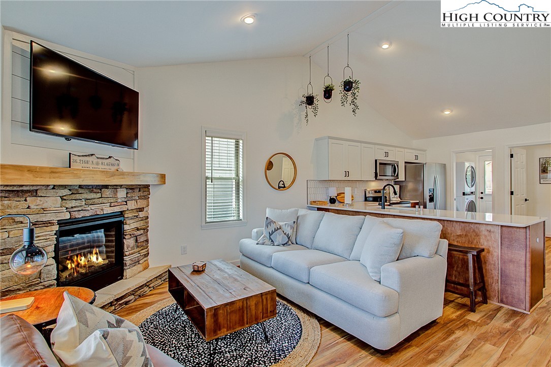 142 Casey Overlook Lane, Unit 82 Boone, NC 28607 - Photo 9 of 43 a living room with furniture a flat screen tv and a fireplace