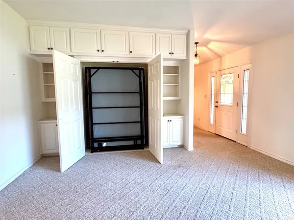 a view of a livingroom with a ceiling fan and window