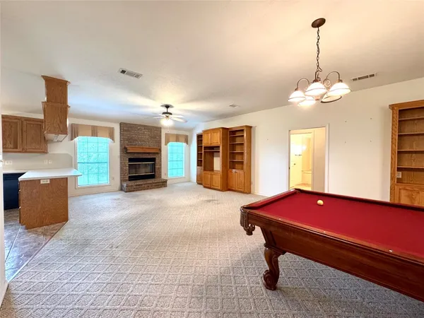 a view of kitchen with furniture and a refrigerator