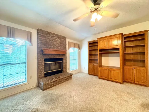 a view of a kitchen with a stove cabinets a ceiling fan and wooden floor