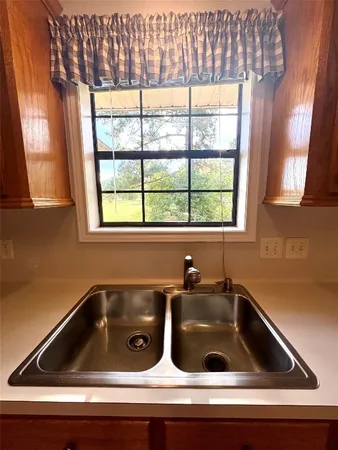 a kitchen with stainless steel appliances granite countertop a sink and wooden cabinets