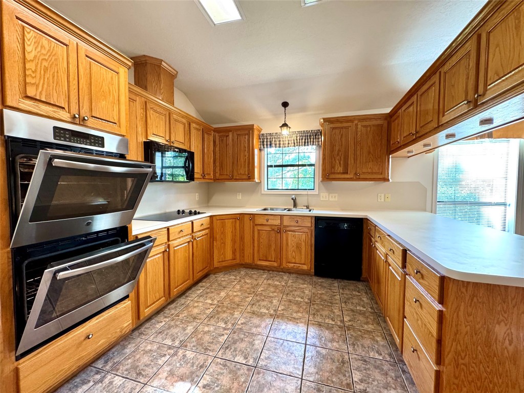 20 Shallow Springs Trinity, TX 75862 - Photo 26 of 48 a kitchen with stainless steel appliances granite countertop a sink and wooden cabinets