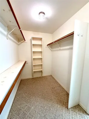 an empty room with a empty space and a ceiling fan