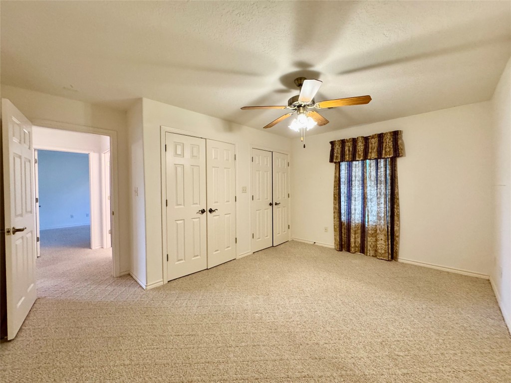 20 Shallow Springs Trinity, TX 75862 - Photo 34 of 48 an empty room with chandelier fan and windows
