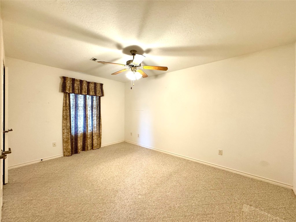 20 Shallow Springs Trinity, TX 75862 - Photo 35 of 48 an empty room with a empty space and a ceiling fan