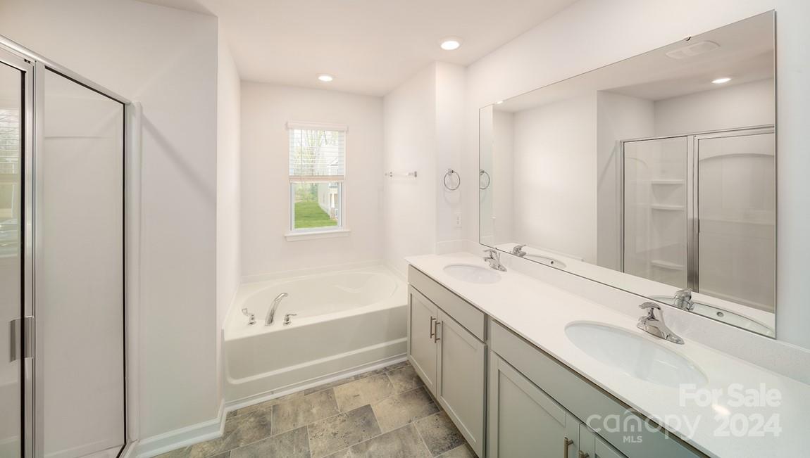 19 Dandelion Road Fletcher, NC 28732 - Photo 11 of 13 a bathroom with a tub sink and mirror