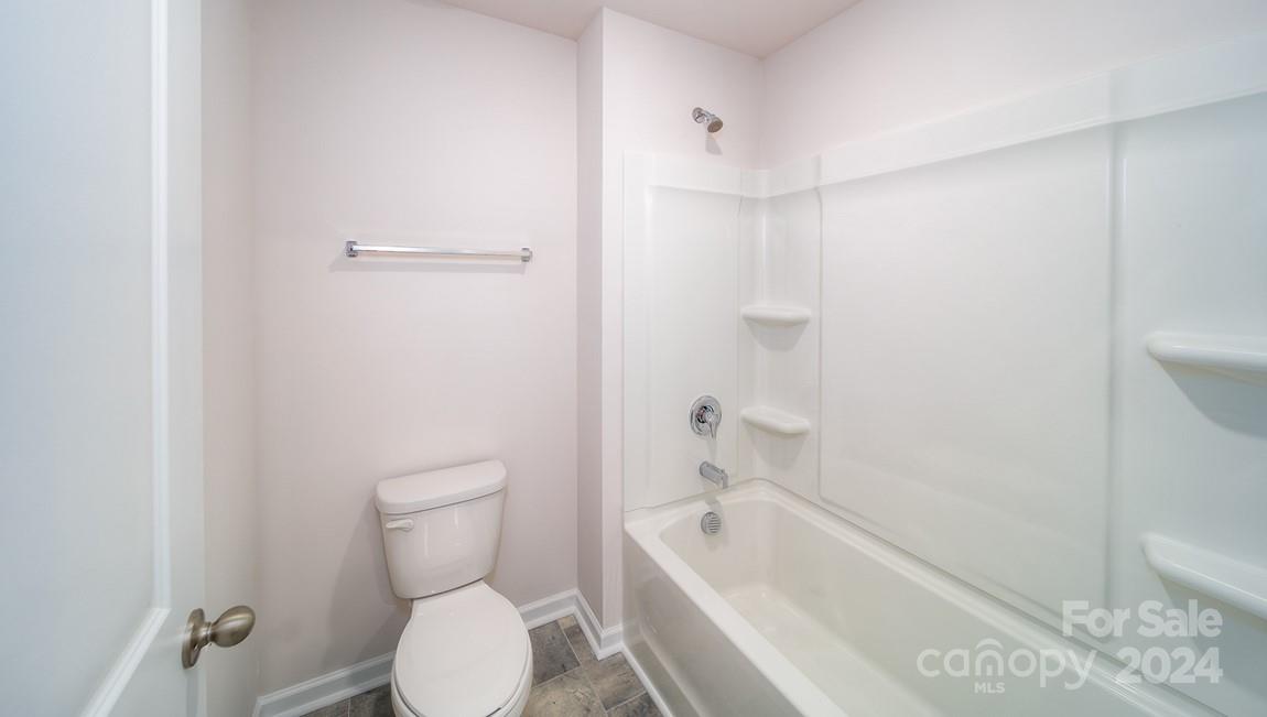 19 Dandelion Road Fletcher, NC 28732 - Photo 12 of 13 a bathroom with a toilet and a bathtub