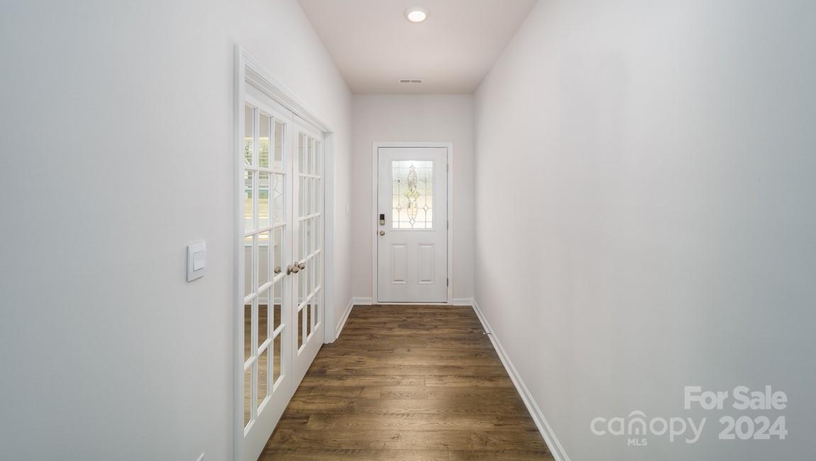 19 Dandelion Road Fletcher, NC 28732 - Photo 2 of 13 a view of a hallway with wooden floor and a bathroom