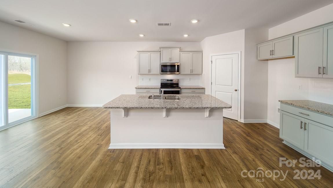 19 Dandelion Road Fletcher, NC 28732 - Photo 5 of 13 a view of kitchen with granite countertop stainless steel appliances refrigerator sink and cabinets