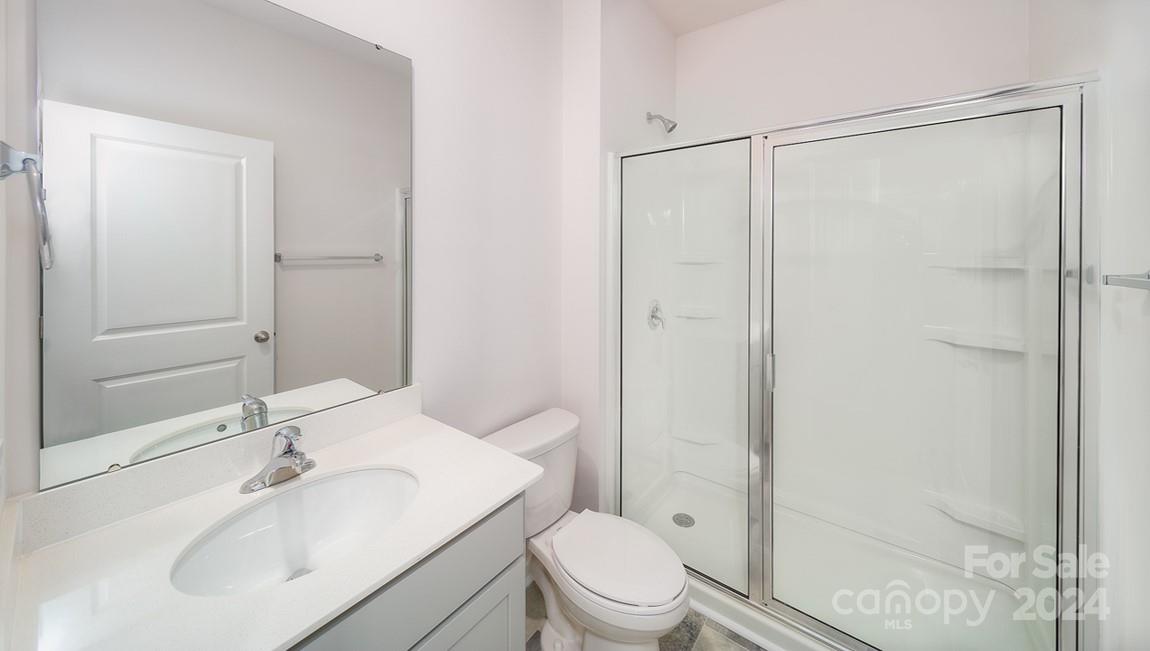 19 Dandelion Road Fletcher, NC 28732 - Photo 10 of 13 a bathroom with a sink toilet and shower