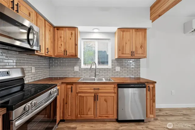 a view of a room with wooden floor and small window