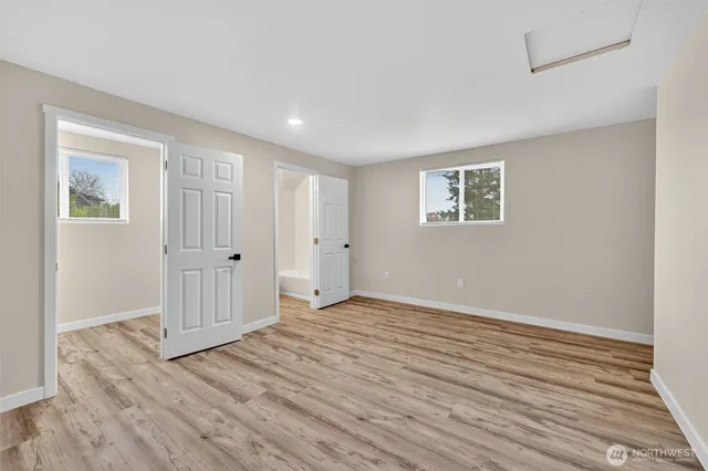 a bathroom with a toilet a sink and mirror