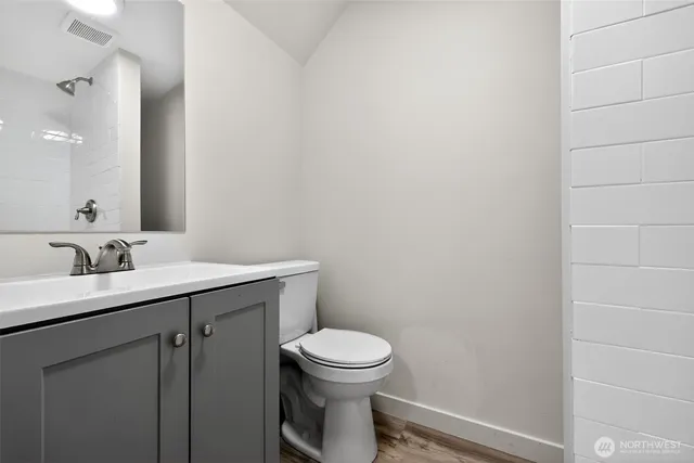 a view of a room with wooden floor and white walls