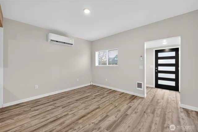 a view of wooden floor and windows in a room