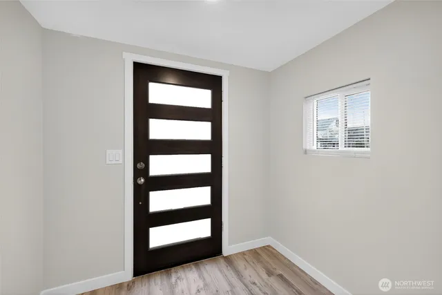 a view of a room with wooden floor and cabinet