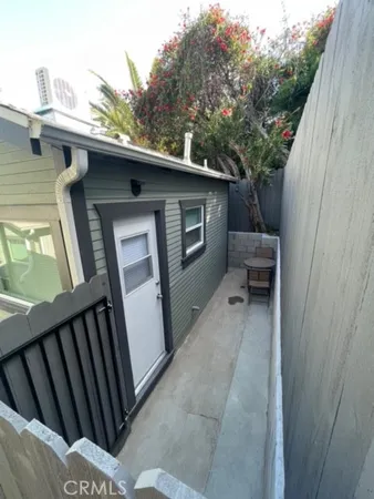 a view of backyard with outdoor seating and stairs