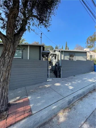 a view of a house with a tree