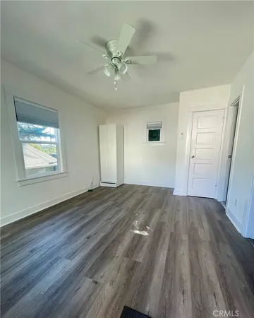 a view of an empty room and wooden floor