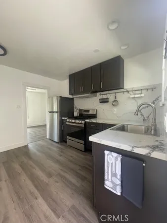 a kitchen with a sink a stove and refrigerator