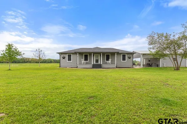 a view of a house with a big yard