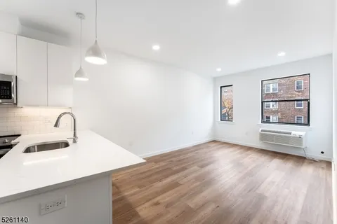 a view of a kitchen with a sink dishwasher and a microwave oven