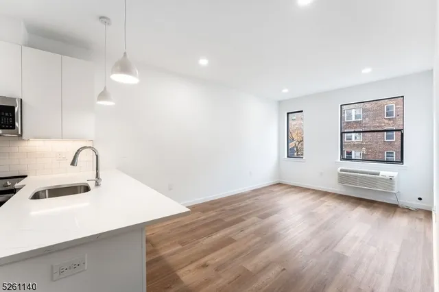a view of a kitchen with a sink dishwasher and a microwave oven