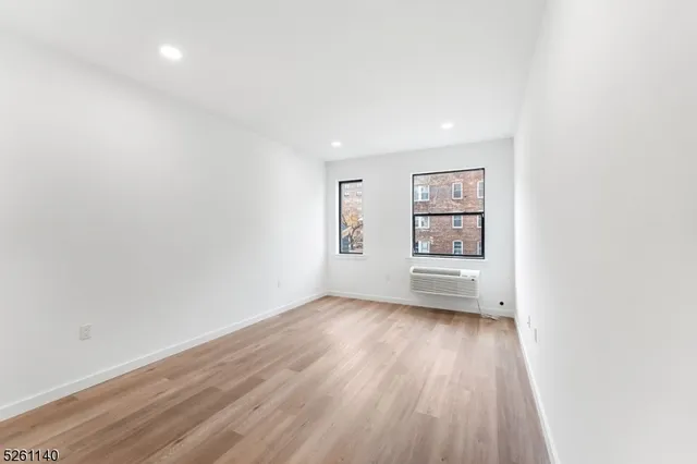 a bedroom with bed and a potted plant