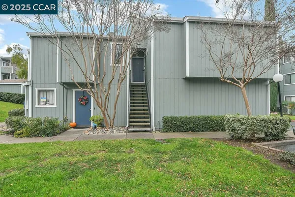 a view of a house with a yard and plants